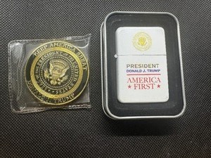 lot 32 image: NOS President Trump Memorabilia. Heavy black and gold plated medallion and new monogrammed lighter.  Both from his first term in office.