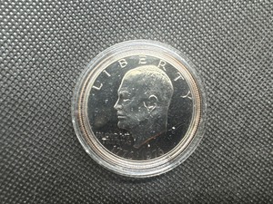 lot 47 image: 1976 S Gem Proof Eisenhower Dollar in Capsule. Clad, deep mirrors, essentially flawless.