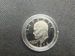 lot 49 image: 1978 S Gem Proof Eisenhower Dollar in Capsule. Clad, deep mirrors, essentially flawless.