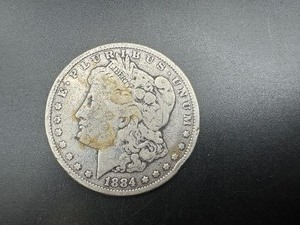 lot 67 image: 1884 Morgan Dollar. Average Circulation. Honest wear and patina.