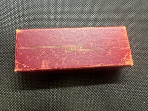 lot 77 image: US WW2 Era OPA Red Point Food Ration Tokens. Includes a misc cornucopia stamps and WW2 Era Swank jewelry box.