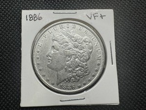 lot 85 image: 1886 VF Morgan Dollar. Cleaned.