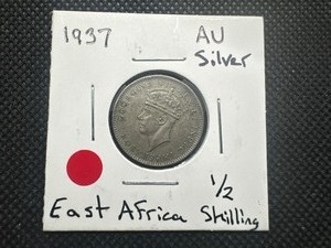 lot 99 image: 1937 Scarce AU Sliver East Africa 12 Shilling.  Problem free, honest patina.  Good luck finding another in this condition.