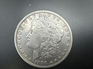 lot 86 image: 1888 O Morgan Dollar. Average circulation. Problem free, honest patina.