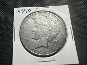 lot 87 image: 1934 D Peace Dollar. Average circulation. Honest wear, honest patina.