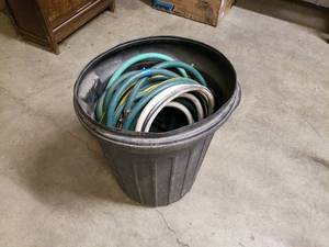 lot 33 image: Garbage can full of garden hose