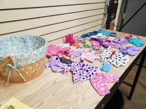 lot 51 image: Basket full of doll clothes