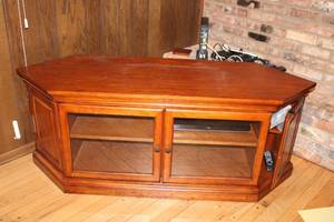 lot 62 image: Corner Media Cabinet with Glass Doors and Wooden Finish