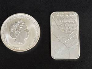lot 77 image: 2022 Tuvalu 1 Dollar 007 Coin and Royal Mint Silver Bar