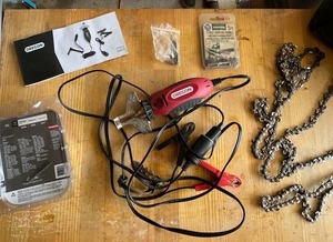 lot 34 image: Oregon 12V Chain Saw Chain Grinder w Grinding Stones and 14 Used Chains