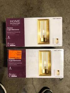 lot 28 image: Lot of Home Decorators Collection Closmere 5 in. 1-Light Brushed Gold Mid-Century Modern Wall Sconce with Clear Glass Shade  Customer Returns See Pictures