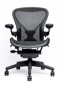 lot 19 image: MSRP $2000 Herman Miller Aeron Chair. Designed for serious comfort with breathable mesh, full ergonomic adjustability, and patented tilt for natural movement. Waterfall seat edge reduces leg pressure. The gold standard in office seating