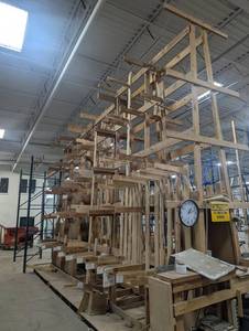 lot 69 image: Massive Custom-Built Wooden Racking  25 Long x 7 Wide x 16 Tall Built for serious storageideal for millwork, molding, lumber, or workshop organization. Heavy-duty structure with tons of slots and levels. Great for warehouses or repurposing