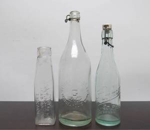lot 91 image: 3 Antique Embossed Glass Bottles - HAMM Beer Bottle wStopper, GLUEK & My Wifes Salad Dressing