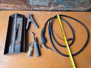 lot 112 image: Tweeco Style 12 Nozzle designed for gas diffusers, a welding clamp, a welding gun with cable, and a metal tool tray