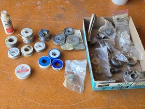 lot 248 image: Assorted Plumbing and Soldering Supplies including  liquid soldering flux, lead-free solder paste, solder wire, pipe repair tape, and various metal fittings