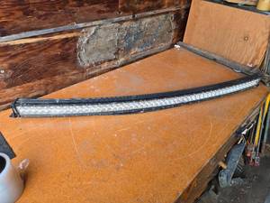 lot 259 image: Curved LED Light Bar with Mounting Brackets approximately 52 inches long,