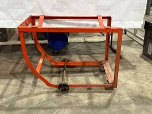lot 711 image: Red Metal Drum Cradle with Wheels for Industrial Use