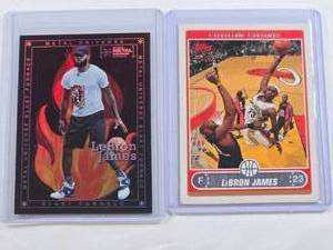 lot 229 image: Lot of 2 LeBron James Basketball Cards -2021 Metal Universe 2005 Topps