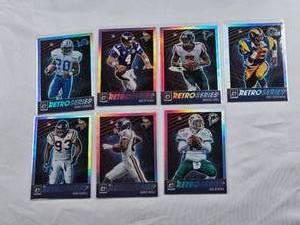 lot 310 image: Lot of 7 Retro Series Prizm and Inserts Football Cards Featuring Barry Sanders, Brett Favre, Michael Vick, Eric Dickerson, John Randle, Randy Moss, and Dan Marino
