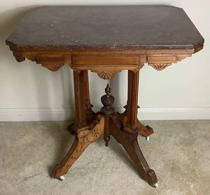 lot 116 image: Victorian Hand Carved Parlor Table on Wheels with Marble Top