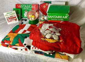 lot 280 image: Miscellaneous SantaBear Collection - Outoor Flag Cookie Mold, 2 Decorative Water Globes, Button Covers, 1996 Throw Blanket, Santa Bear Sweatshirts (2 L and 3 XL), and Small Photo Album