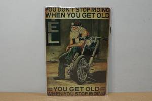 lot 167 image: Novelty Metal Sign - Get Old When Stop Riding