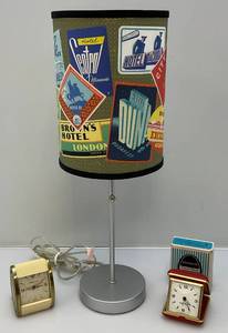lot 24 image: Misc. Vintage Westclox Brand Travel Clocks 1 Original Box & Vintage Travel Themed Table Lamp