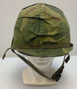 lot 127 image: WWII Vietnam War Era M1 Helmet Shell With Liner And Original Camo Leaf Cover And Soldiers Name Written On Strap