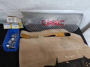 lot 87 image: GMC Front Grill, Dashboard Pad, and Tonneau Cover Brackets Set