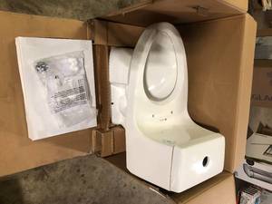 lot 61 image: Glacier Bay McClure 12 inch Rough In One-Piece 1.1 GPF1.6 GPF Dual Flush Elongated Toilet in White Seat Included Missing Parts  Customer Returns see Pictures