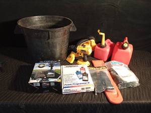 lot 53 image: Tub of auto accessories, new tiedowns, chainsaw chain guard, Dewalt battery operated tools, and 2 gas cans
