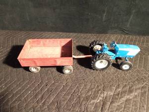lot 80 image: Metal toy tractor with an Ertyl trailer