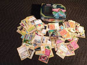 lot 67 image: Pokmon tin of 100 Pokmon trading cards