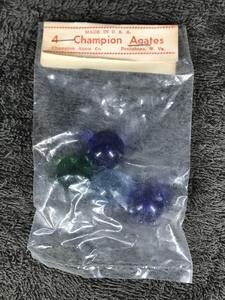 lot 204 image: Set of 4 Collectible  Champion Agate Marbles in Original Package