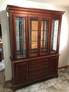 lot 18 image: Lighted 2 Piece Solid Wood Hutch with 2 Tier Glass Shelving, Glass Mirror in the Back, Lead Framed Glass in the Front, 5 Drawers and 2 Cabinets with Shelving Inside