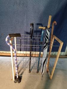 lot 145 image: 4 Tier floor standing shelf with wire shelves and wood frame. canes and umbrella