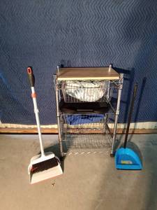 lot 142 image: Rolling kitchen island with cutting board top and 3 basket drawers, 2 dustpans, broom, pet bed and more