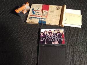 lot 94 image: Collectibles Home Depot tin, Servicemens correspondence kit, Duck Dynasty photos
