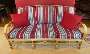 lot 5 image: Vintage Bamboo Sofa with Red and Blue Striped Cushions