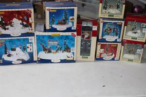 lot 143 image: 10 Piece Lemax Christmas Buildings Dog Show Pageant, Santa Water Tower, Snowball Fight Merry Go Round, Santa Hammock