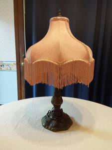 lot 115 image: Vintage Table Lamp with an ornate base with intricate detailing and a fringed lampshade