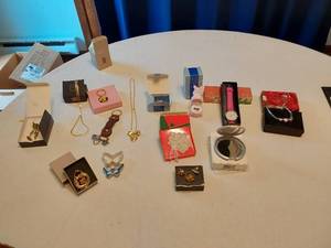 lot 125 image: Assorted Jewelry and Accessories including Avon Watch, Pendants, Necklaces, and Compact Mirror