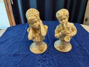 lot 149 image: Pair of Universal Statuatory Corp. Kendrick 1971 Sculptures - Girl with Hands on Cheek, Boy Playing Saxaphone