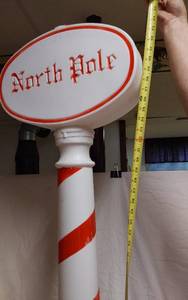 lot 312 image: North Pole Christmas Blow Mold with Candy Cane Striped Post about 44 Tall