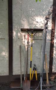 lot 409 image: Garden Tools Assortment with Rake, Shovel, and Pick Axe
