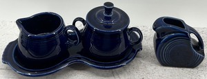 lot 93 image: Fiestaware Cobalt Blue Ceramic Tableware Set with Creamer, Sugar Bowl, Tray and small Pitcher