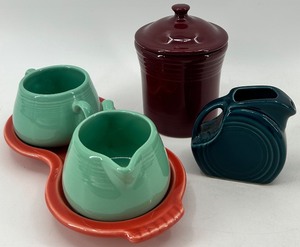lot 98 image: 5 piece assorted Fiestaware set including creamer and sugar with tray, small jar and pitcher
