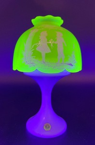 lot 276 image: Westmoreland Vaseline Uranium Glass Lamp with Figural Scene