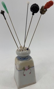 lot 323 image: Antique Porcelain Hat Pin Holder with 5 Hat Pins and 3 Stick Pins